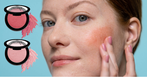 Close-up of a woman smiling slightly at the camera while lightly applying coral-toned blush to her face using her fingers against a blue background with two images of Color Me Beautiful Color Pro Blush in a deep pink and a soft light pink.